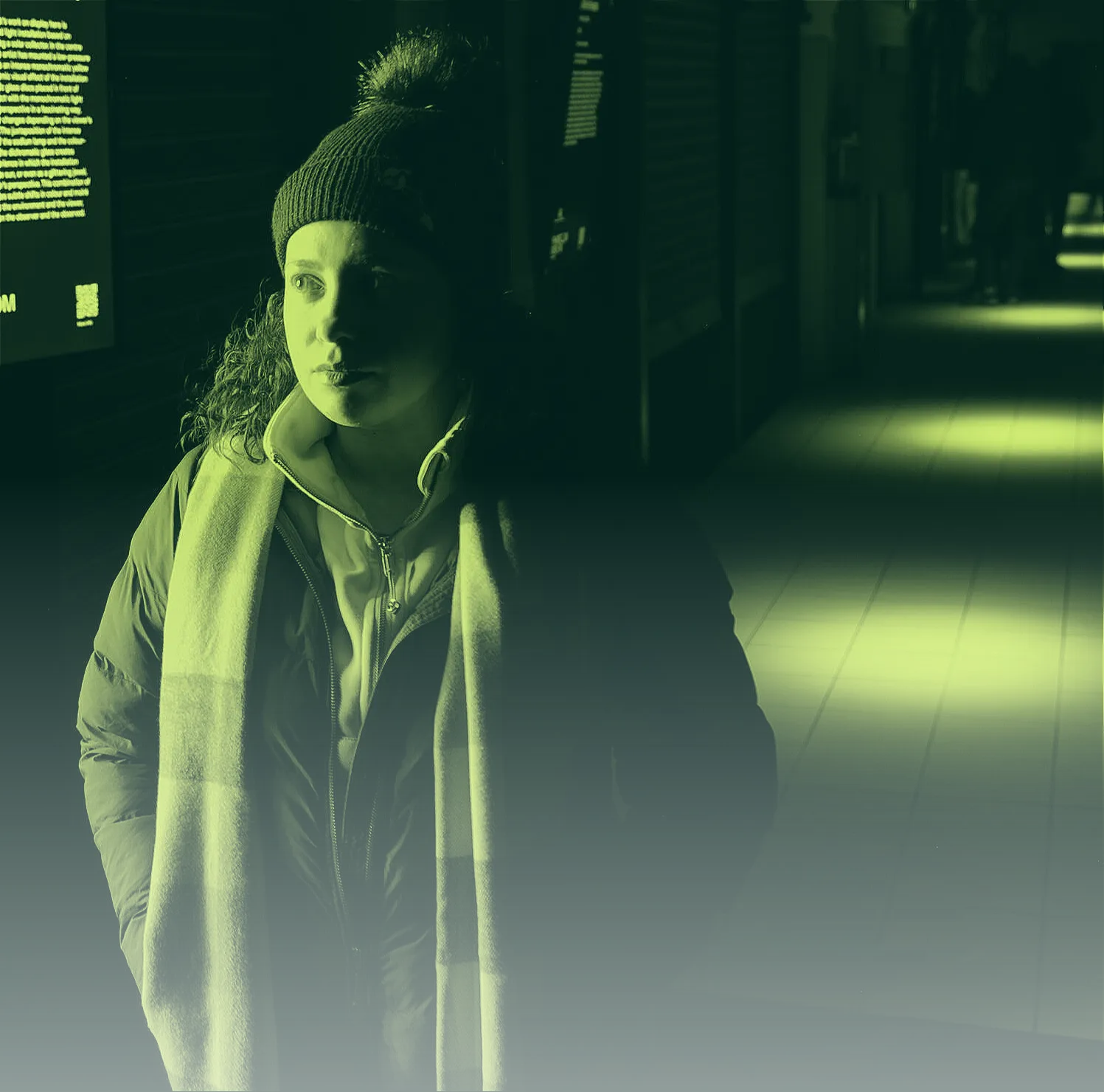 Portrait of Natalie Nieves in a winter hat and scarf, in green-toned light